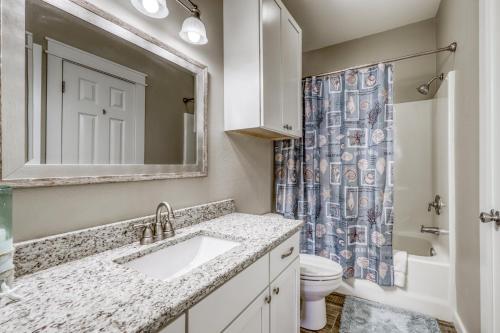 a bathroom with a sink and a toilet and a mirror at Compass Condominiums A3 in Corpus Christi