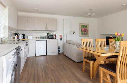 a kitchen and dining room with a table and chairs at 1 bedroom Apartment Ballaghderg Letterkenny in Letterkenny