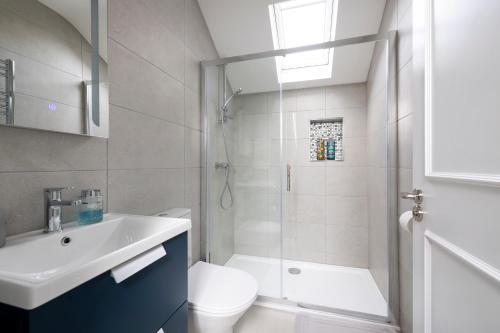 a bathroom with a sink and a toilet and a shower at 1 bedroom Apartment Ballaghderg Letterkenny in Letterkenny