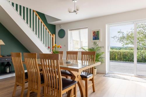 a dining room with a wooden table and chairs at 1 bedroom Apartment Ballaghderg Letterkenny in Letterkenny