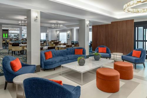 a lobby with blue couches and orange pillows at Courtyard Palo Alto Los Altos in Palo Alto