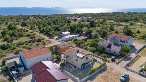 an aerial view of a house with the ocean in the background at Apartment Draga in Vir