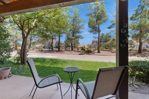 a patio with two chairs and a table and grass at Sedona Sky Sanctuary in Sedona