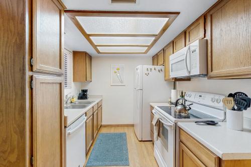 a kitchen with white appliances and wooden cabinets at Sedona Sky Sanctuary in Sedona
