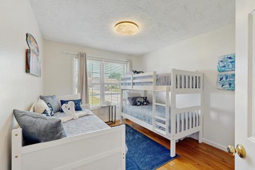 ein Schlafzimmer mit einem Etagenbett und einem Kinderbett in der Unterkunft Maplewood --- 17 Tulane Dr - Ohana House in The Plantations