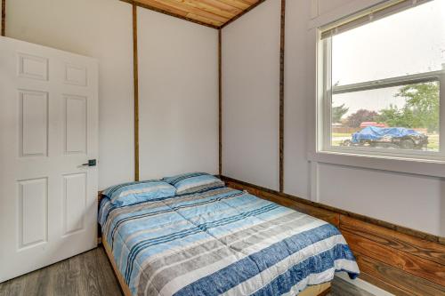 a bedroom with a bed and a window at Near Twilight Sites and Scenic Hikes Forks Apt in Forks