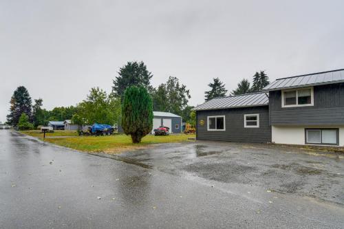 a house with a tree in the middle of a driveway at Near Twilight Sites and Scenic Hikes Forks Apt in Forks