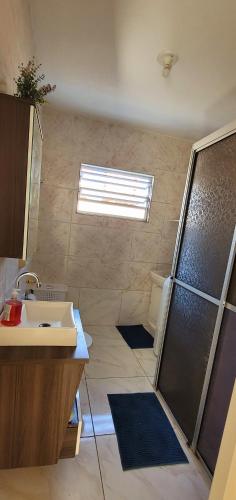a bathroom with a shower and a sink at Casa Ensolarada in Itapema