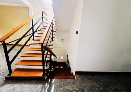 a stairway in a building with wooden steps at Kings Town Hotel in Anuradhapura