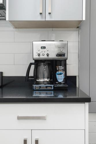 a coffee maker on a counter in a kitchen at Cozy 1BR on Harrison Lake in Harrison Hot Springs