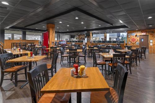 a dining room with wooden tables and chairs at Best Western Royal Plaza Hotel and Trade Center in Marlborough