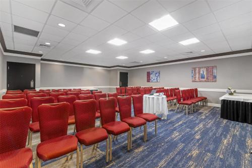 a conference room with red chairs and a table at Best Western Royal Plaza Hotel and Trade Center in Marlborough