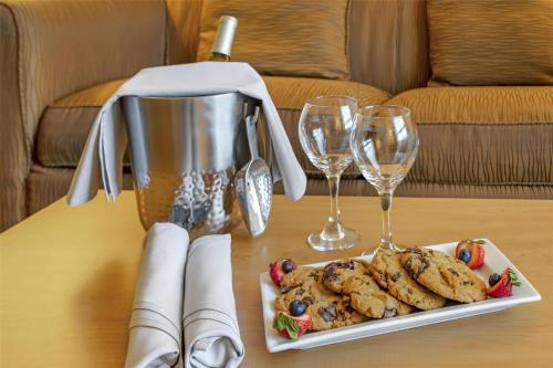 a table with a plate of cookies and wine glasses at Best Western Royal Plaza Hotel and Trade Center in Marlborough