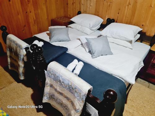 two twin beds with pillows and towels on them at Seoski dom 