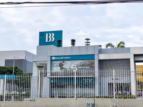 a building with a sign on top of it at Casa con Piscina Privada, Asadero Bbq y 4 cuartos en Guayaquil in Guayaquil