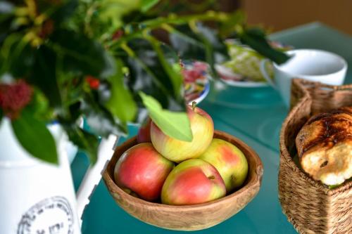 a bowl of apples sitting on a table with a table at 1 Coed y Llyn in Abersoch
