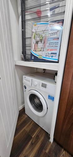 a washer and dryer in a room with a door at Ground floor outdoor ease in Cardiff