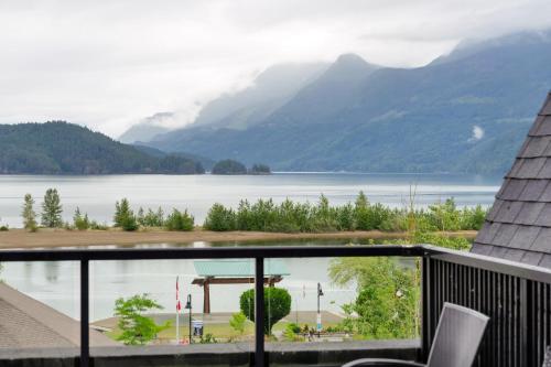 a view of a lake from the balcony of a house at Cozy 1BR on Harrison Lake in Harrison Hot Springs