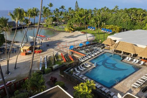an aerial view of a resort with a pool and a beach at Courtyard by Marriott King Kamehameha's Kona Beach Hotel in Kailua-Kona