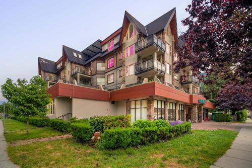 a large building with a lot of windows at Cozy 1BR on Harrison Lake in Harrison Hot Springs