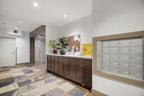 a large room with cabinets and a counter at 1BR Lakeside Getaway on Harrison Lake in Harrison Hot Springs
