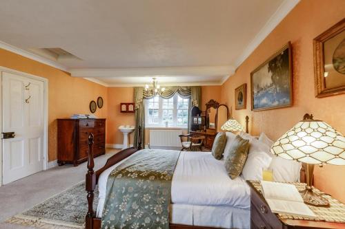 a bedroom with a bed and a desk and a window at North Wing at Penmaen in Pwllheli