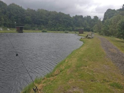 a body of water with a fishing pole in it at 4 person holiday home in Hovborg-By Traum in Hovborg