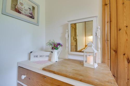 een spiegel bovenop een dressoir in een kamer bij Mole Cottage in Parracombe