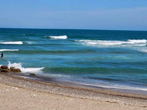 a person is standing in the water at the beach at 6 person holiday home in Thisted-By Traum in Torsted