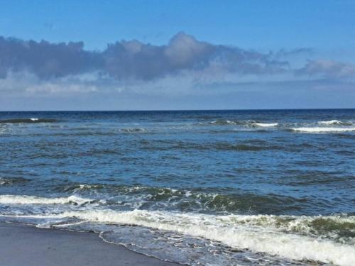 a body of water with a beach with waves at 6 person holiday home in Thisted-By Traum in Torsted