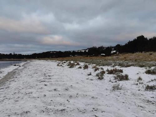 a snowy beach with snow on the ground at 6 person holiday home in Nykøbing Sj-By Traum in Klint