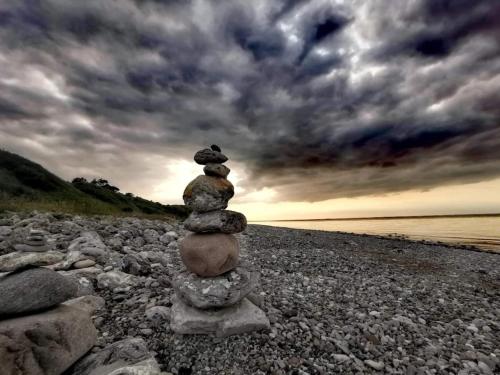 a stack of rocks sitting on a rocky beach at 6 person holiday home in Nykøbing Sj-By Traum in Klint