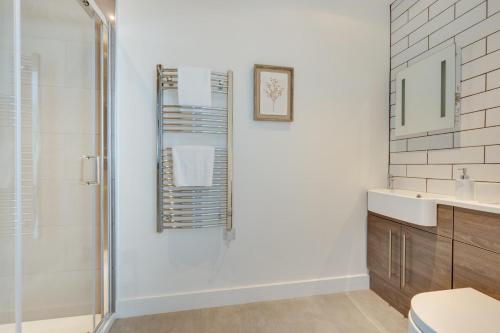 a bathroom with a shower and a sink at Neptune in Saundersfoot