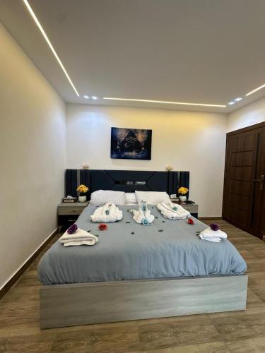 a bedroom with a large bed with towels on it at king pyramids in Cairo