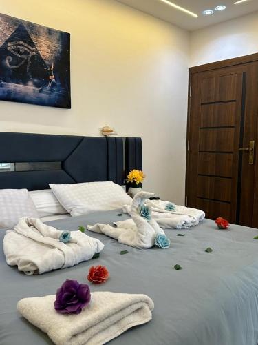 a bed with towels and flowers on top of it at king pyramids in Cairo