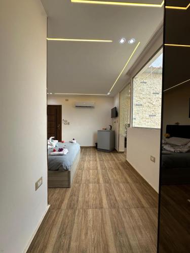 a bedroom with a bed and a large window at king pyramids in Cairo