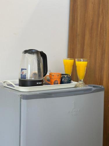 a toaster and two glasses on top of a refrigerator at king pyramids in Cairo