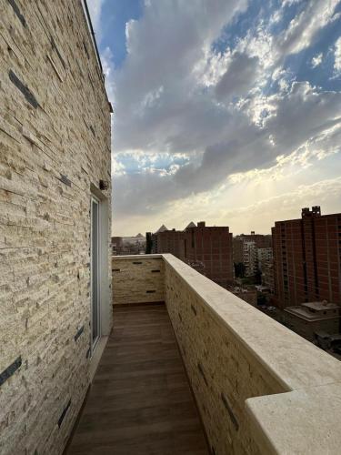 a balcony of a building with a view of a city at king pyramids in Cairo
