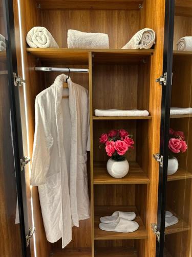 a wooden closet with towels and towels in it at king pyramids in Cairo