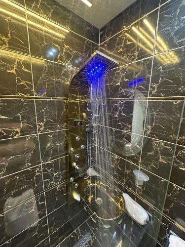 a bathroom with a shower with a black tiled wall at king pyramids in Cairo