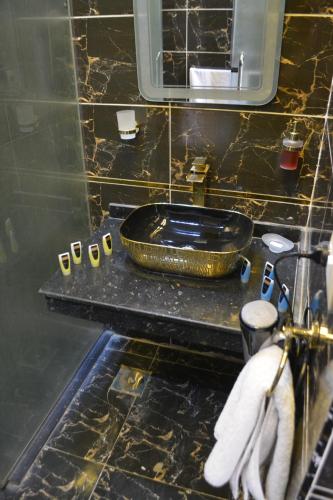 a bathroom with a black counter with a sink at king pyramids in Cairo