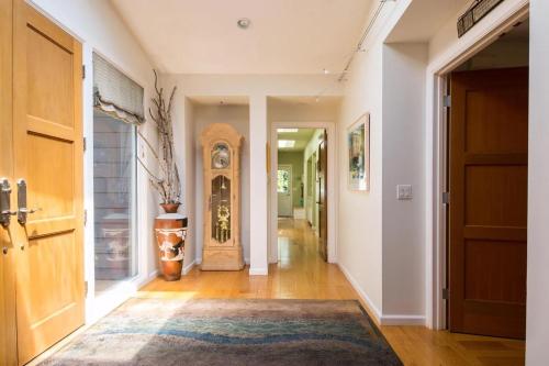 a hallway with a grandfather clock in a house at Wine Country Retreat Zinfandel Lane Villa in St. Helena