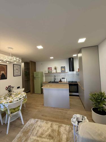 a kitchen and living room with a table and a counter at Super cozy corner in Itʼkhvisi