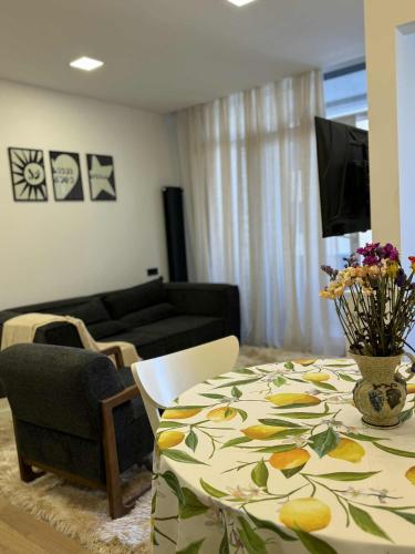 a living room with a table and a couch at Super cozy corner in Itʼkhvisi