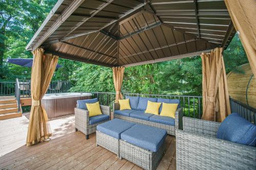 a patio with couches and chairs on a wooden deck at The Newly Built Custom Townhome by Granger Gardens in Ann Arbor