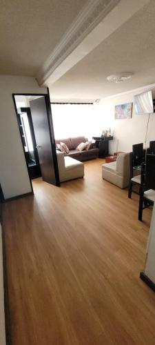 a living room with a mirror and a couch at Apto Duplex Familias Numerosas Centro Pasto in Pasto