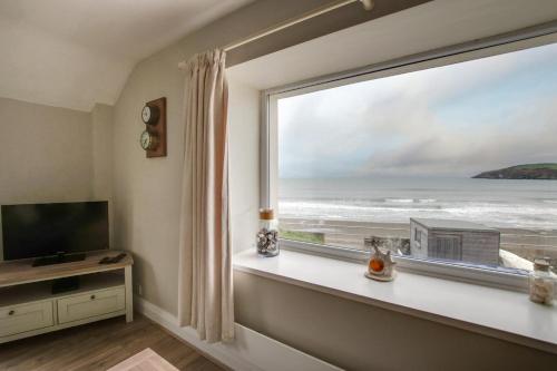 a room with a window with a view of the ocean at Glandon in Aberdaron