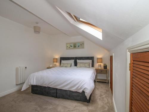 a bedroom with a bed and a skylight at Old Forge Apartment in Wolverley