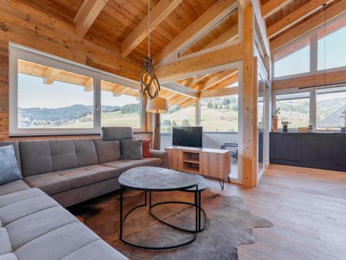 a living room with a couch and a table at Chalet Kolibri in Sankt Lambrecht