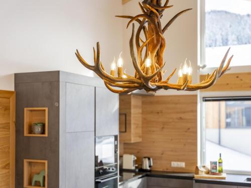 a large antler chandelier hanging in a kitchen at Grebenzen Lodge Pabstin 36B in Sankt Lambrecht